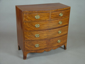 Appraisal: A mahogany bowfront chest early th century of two short