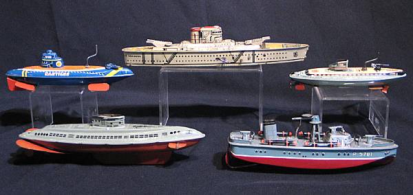 Appraisal: Tin lithographed Ships Grouping of ships includes an articulated Marx