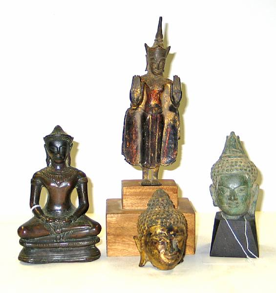 Appraisal: Four Buddhist bronzes Including two Buddha heads one standing figure