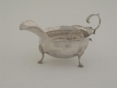 Appraisal: A George III sauceboat on three feet with a wavy