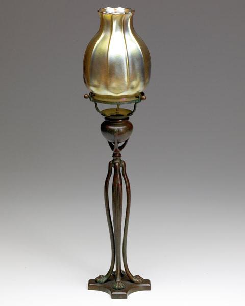 Appraisal: TIFFANY STUDIOS Four-stemmed bronze candlestick with gold Favrile glass shade