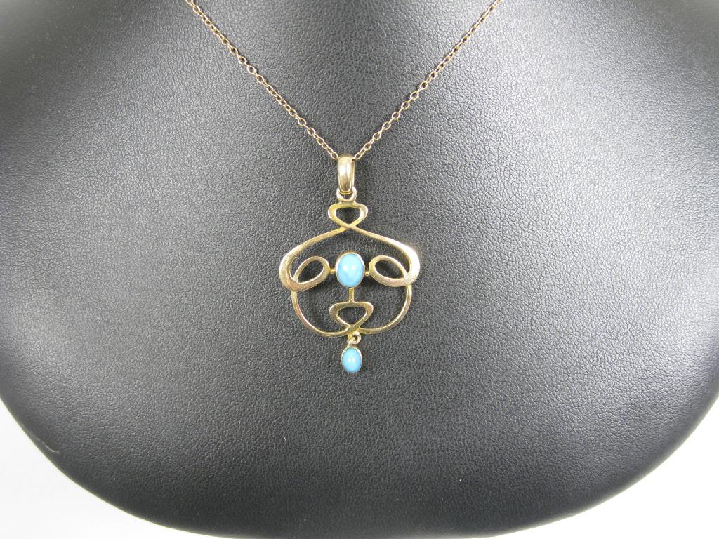 Appraisal: An Art Nouveau style Pendant collet-set two turquoise cabochons on