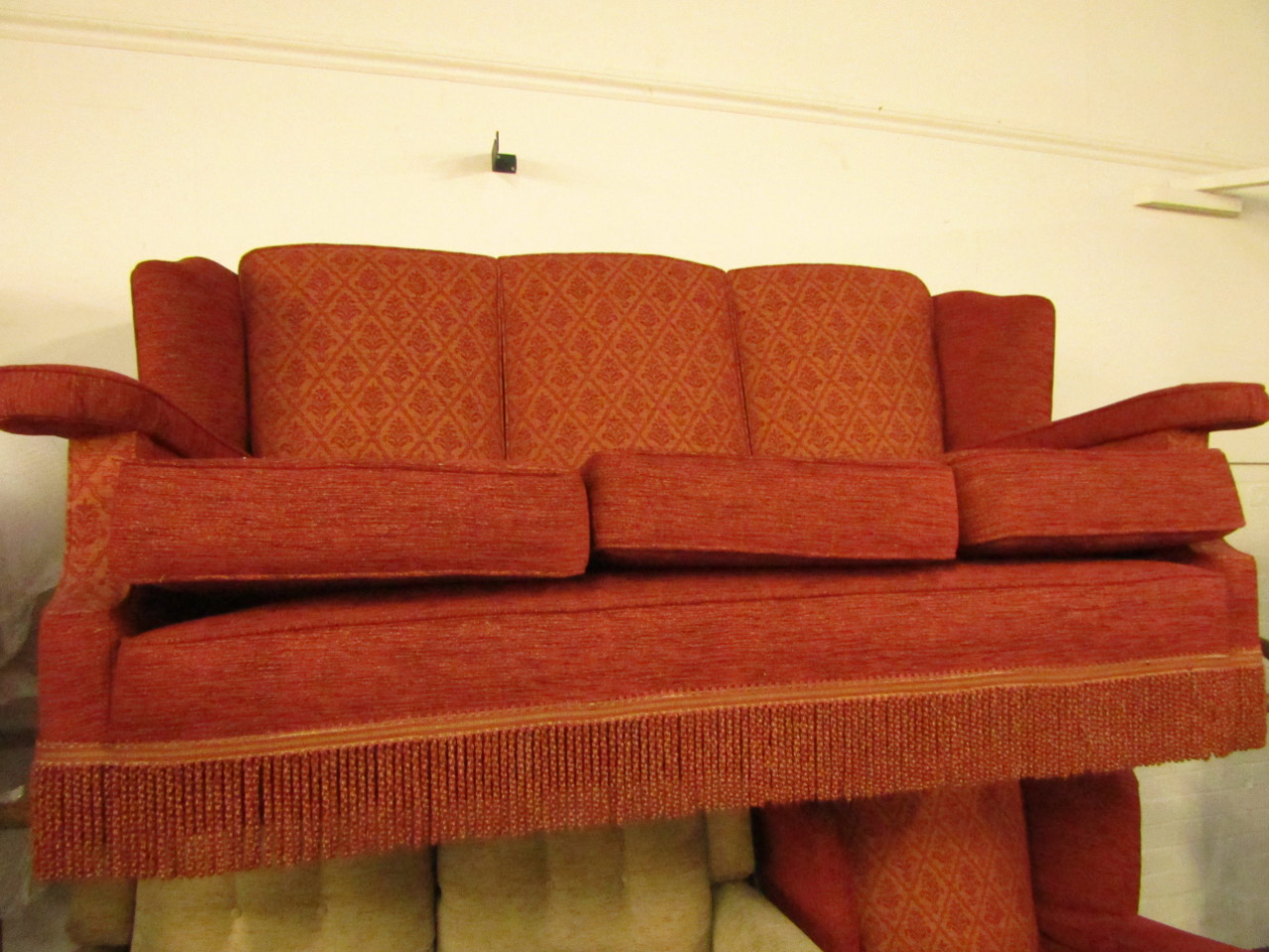 Appraisal: A Harrods wing back three seater sofa and armchair re-upholstered