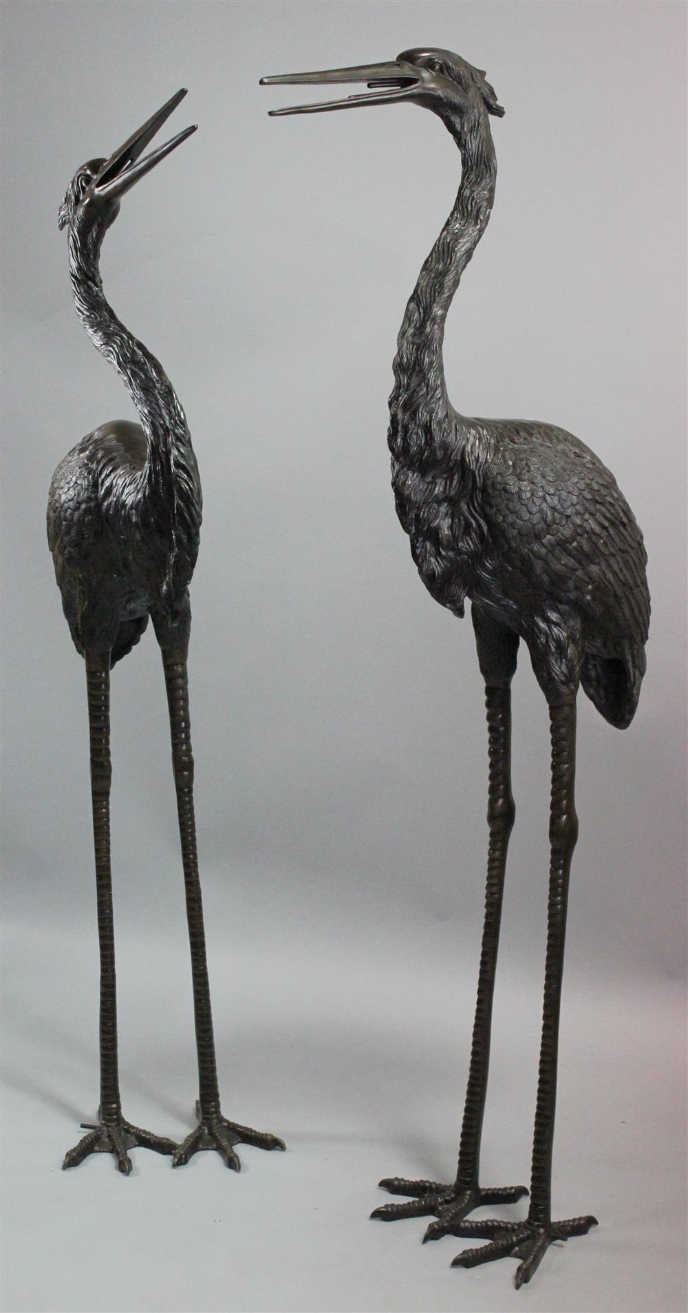 Appraisal: PAIR OF BRONZE MODELS OF CRANES cast in the Japanese