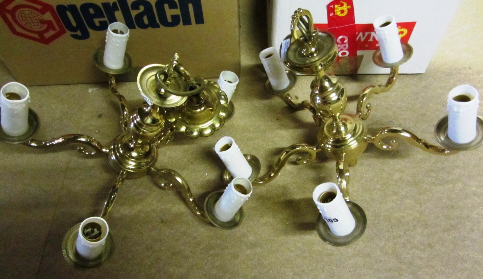 Appraisal: Two modern brass five light chandeliers and an eight light