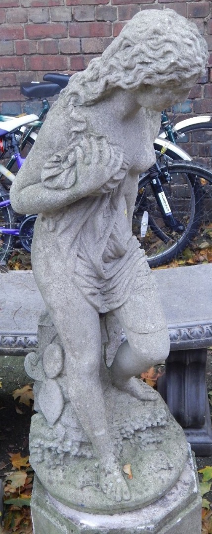 Appraisal: A stone garden statue modelled as Andromeda chained to the