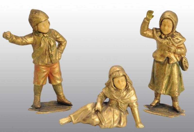 Appraisal: Lot of Bronze Children Description Unmarked with celluloid-type faces Includes