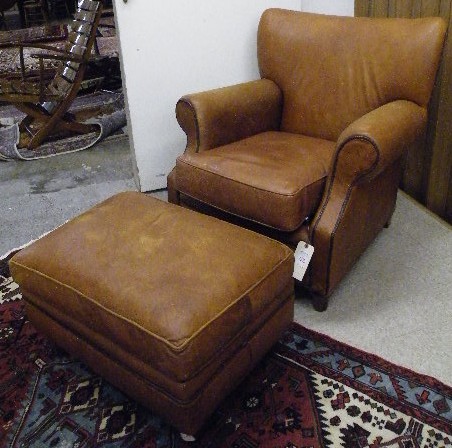 Appraisal: BROWN LEATHER ARMCHAIR OTTOMAN made by Sam Moore Furniture Co