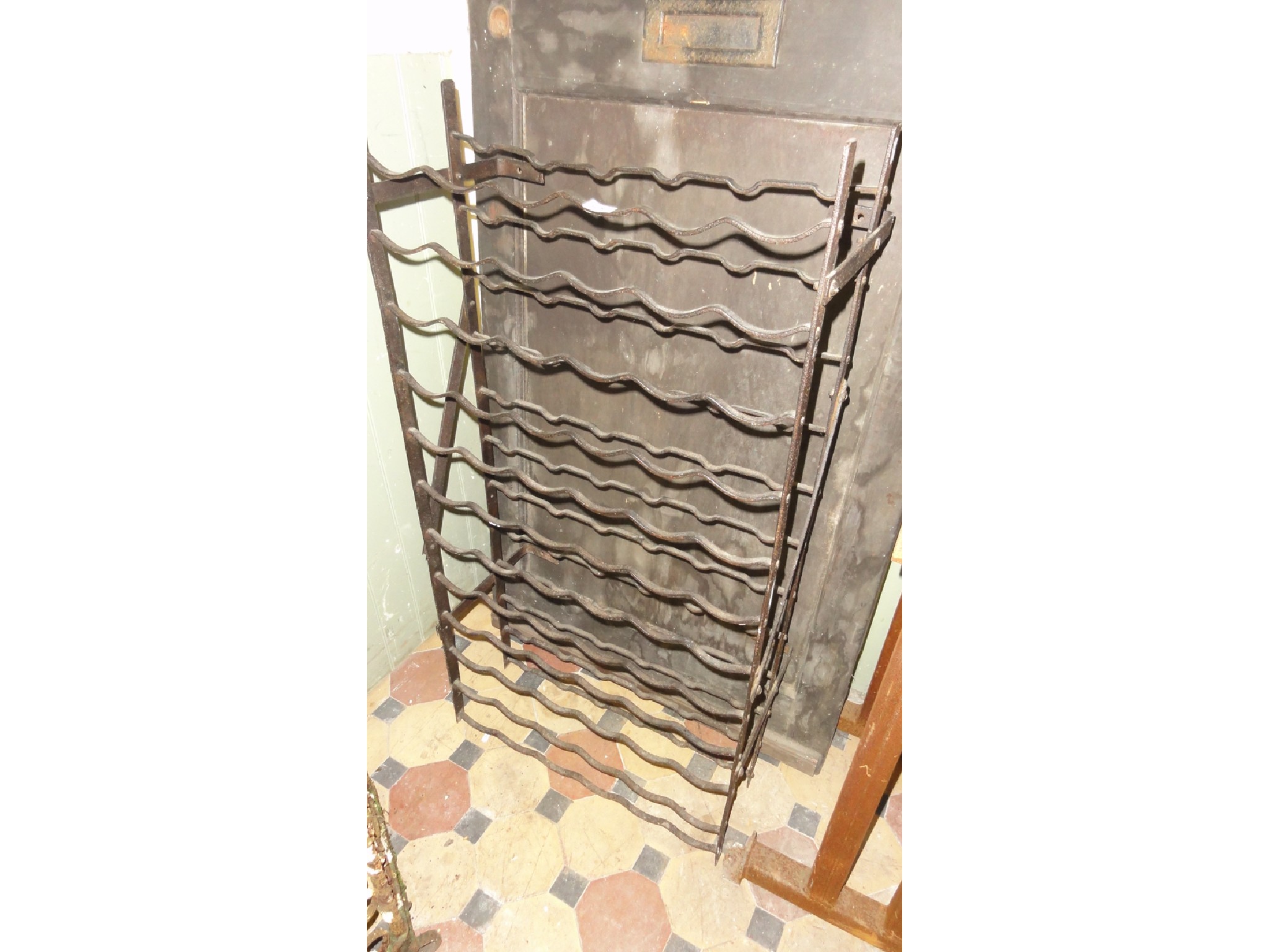 Appraisal: An ironwork wine bottle rack to hold bottles