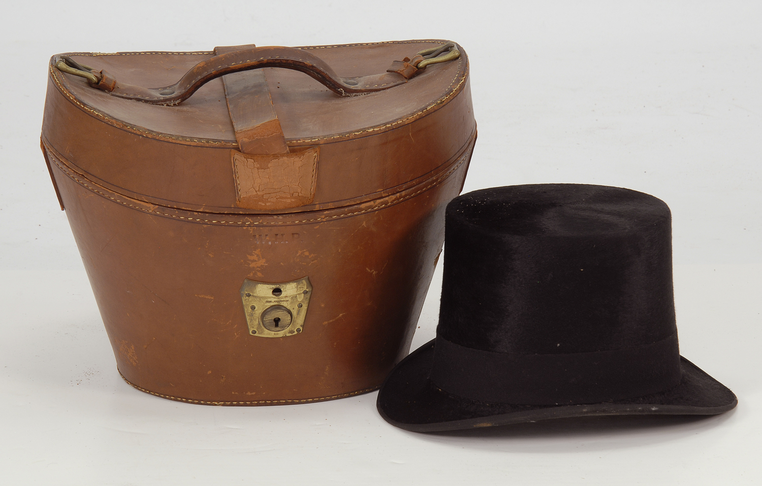 Appraisal: ANTIQUE LEATHER HATBOX WITH TOP HAT Hat in good condition