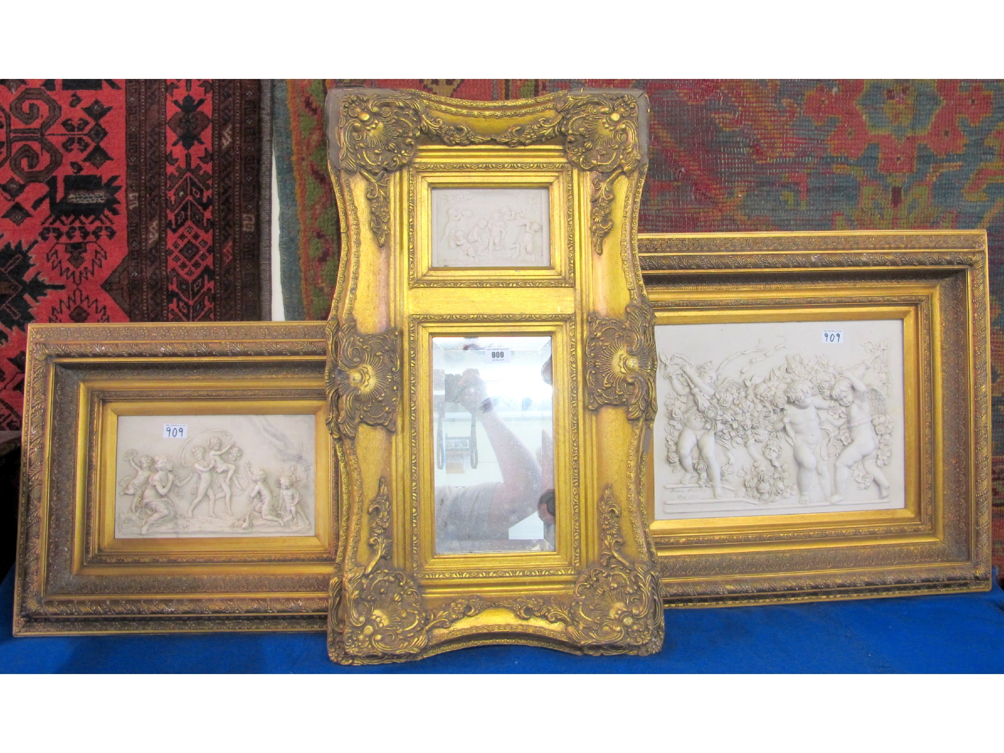 Appraisal: Two gilt framed composition wall plaques and a gilt framed