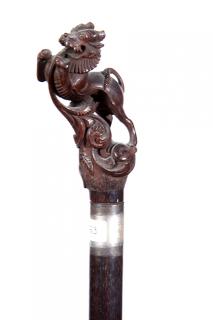 Appraisal: Japanese Dress Cane Ca A carved Foo dog which is