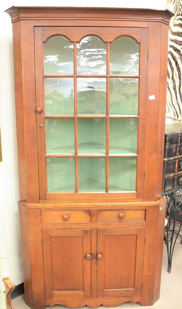 Appraisal: Primitive cherry two-part corner cabinet glazed door top over two