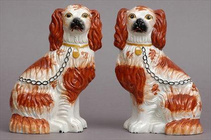 Appraisal: PAIR OF STAFFORDSHIRE RED-SPOTTED SEATED SPANIELS Each with ochre collar