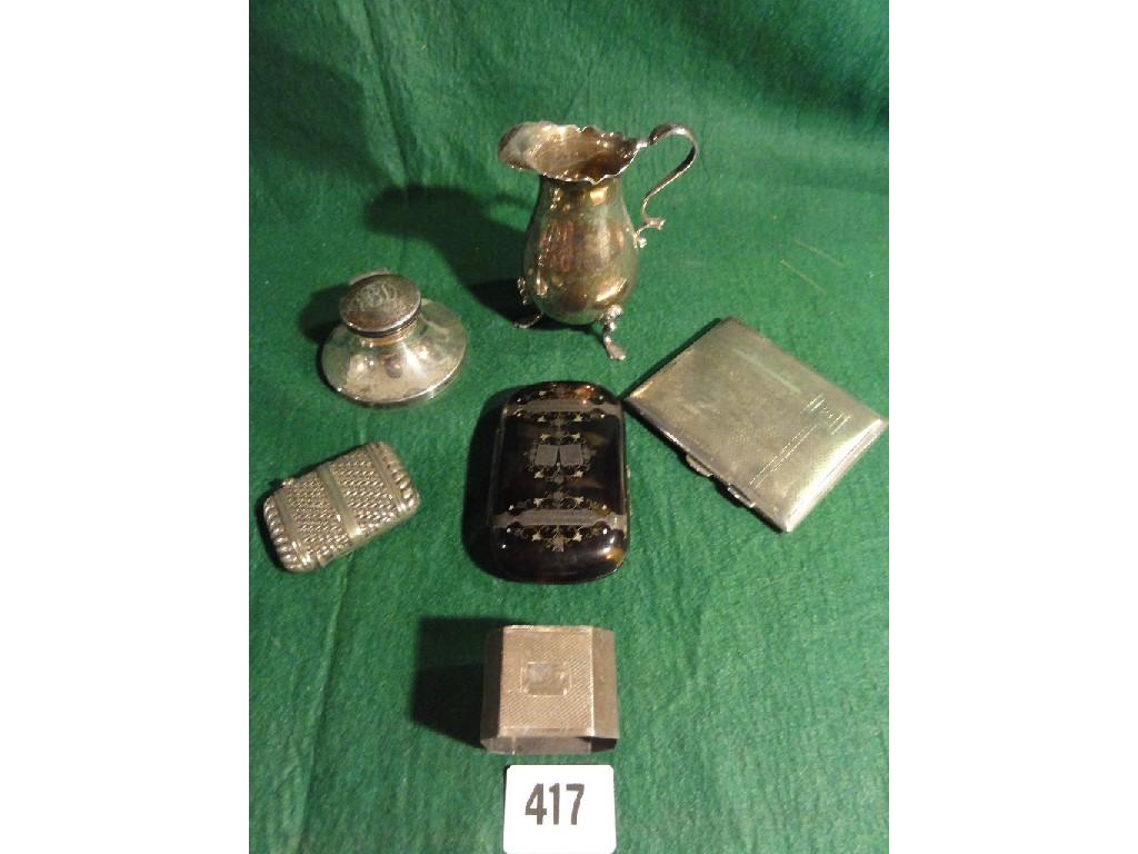 Appraisal: A small silver capstan inkwell a silver creamer a napkin