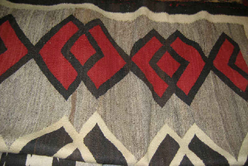 Appraisal: NAVAJO BLANKET The natural tan field shows three rows of