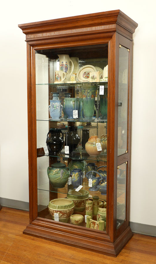 Appraisal: ILLUMINATED DISPLAY CABINET Stepped cornice over beveled glass front side