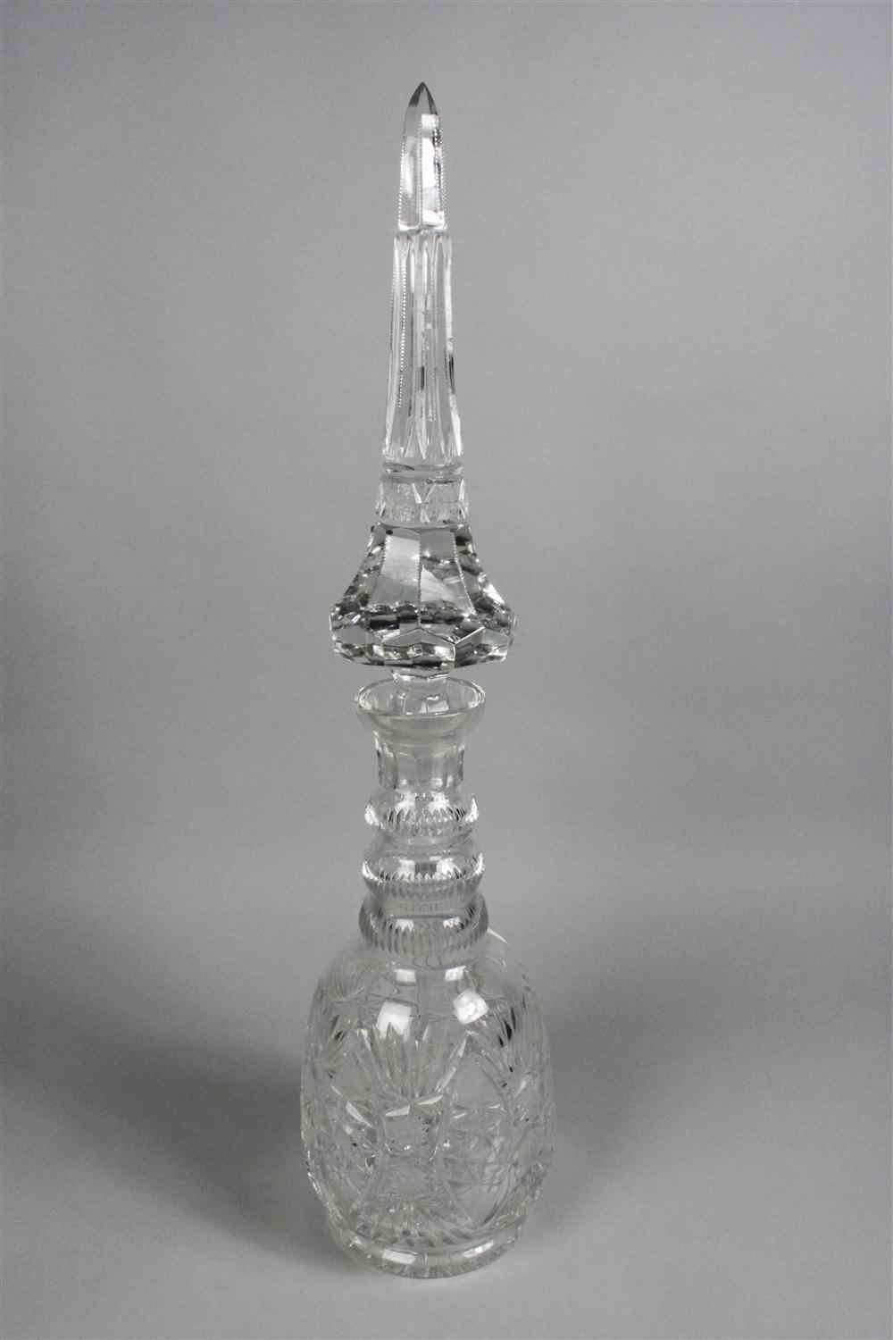 Appraisal: ONE MASSIVE CUT GLASS DECANTER AND STOPPER with paneled spire