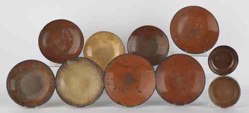 Appraisal: Collection of redware plates and shallow bowls th c ten