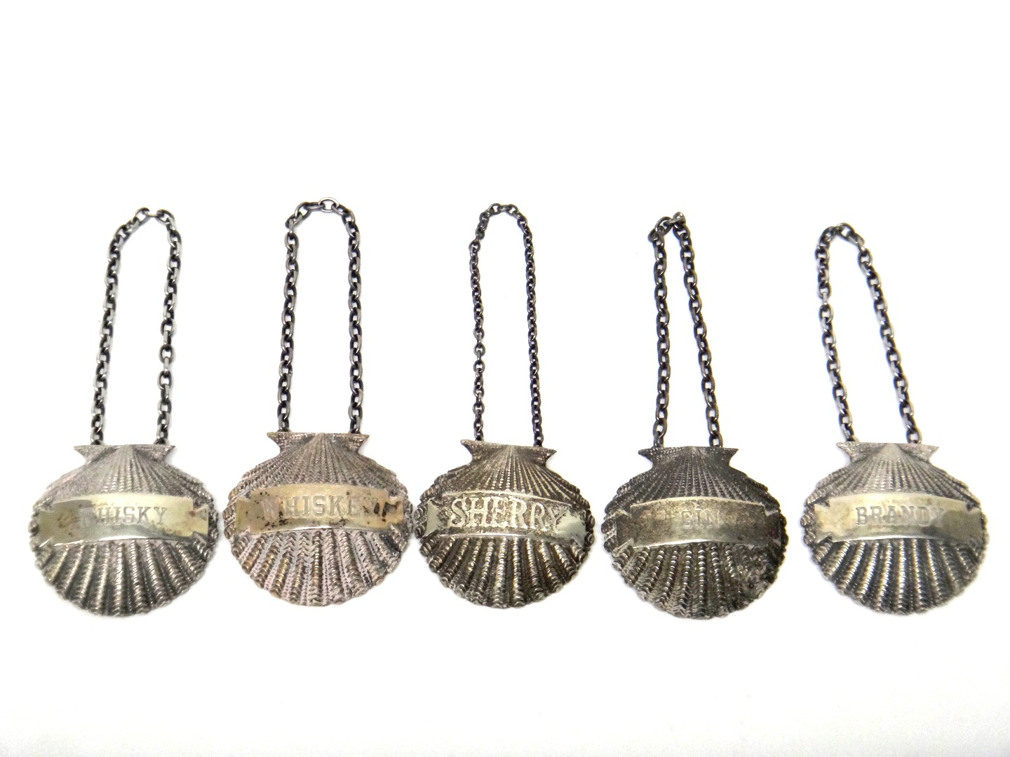 Appraisal: Five silver decanter labels each of cast scallop shell form