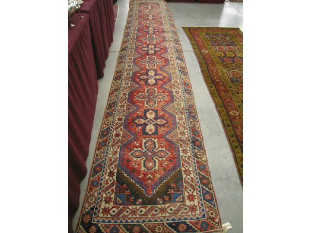 Appraisal: Heriz Persian Handmade Runner geometric medallions reds blues ivory '