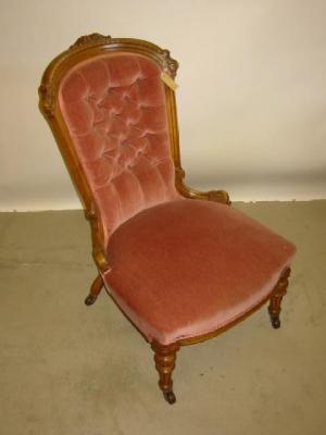 Appraisal: A VICTORIAN WALNUT FRAMED NURSING CHAIR button upholstered in pink