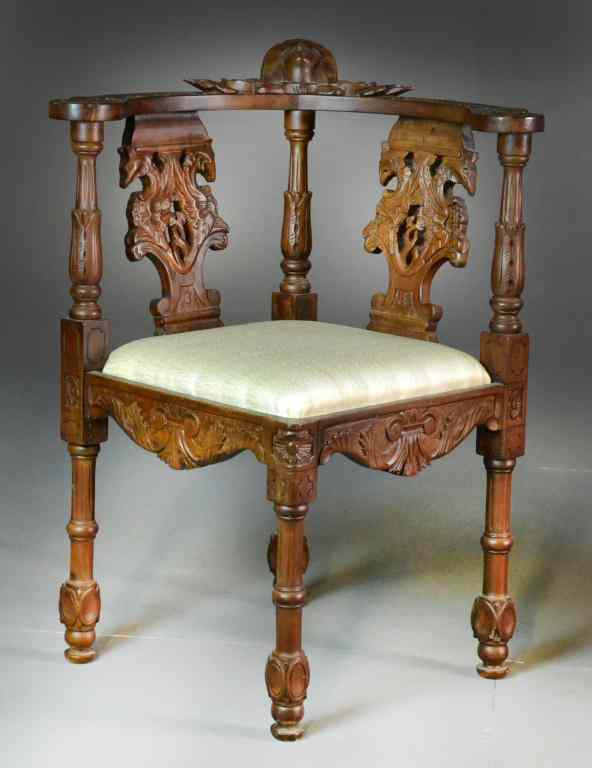 Appraisal: Finely Carved Corner ChairHeavily carved overall with head of young