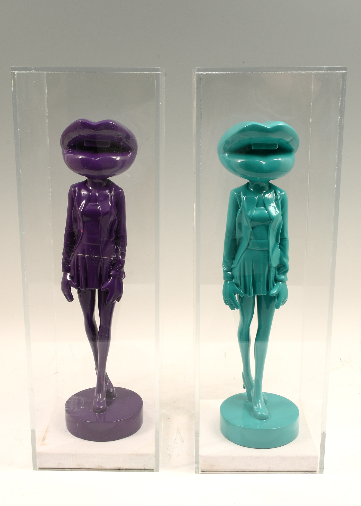 Appraisal: TWO ALEJANDRO PLAZA FEMININE RESIN SCULPTURES One is purple other