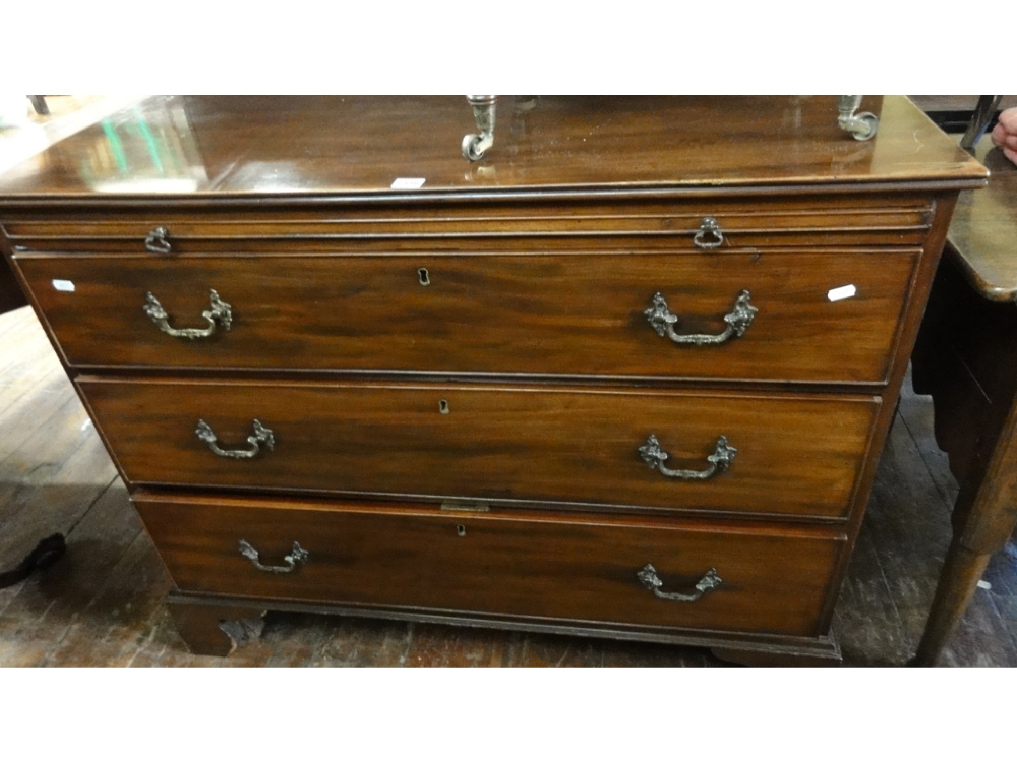 Appraisal: A Georgian mahogany chest of three long drawers accompanied by