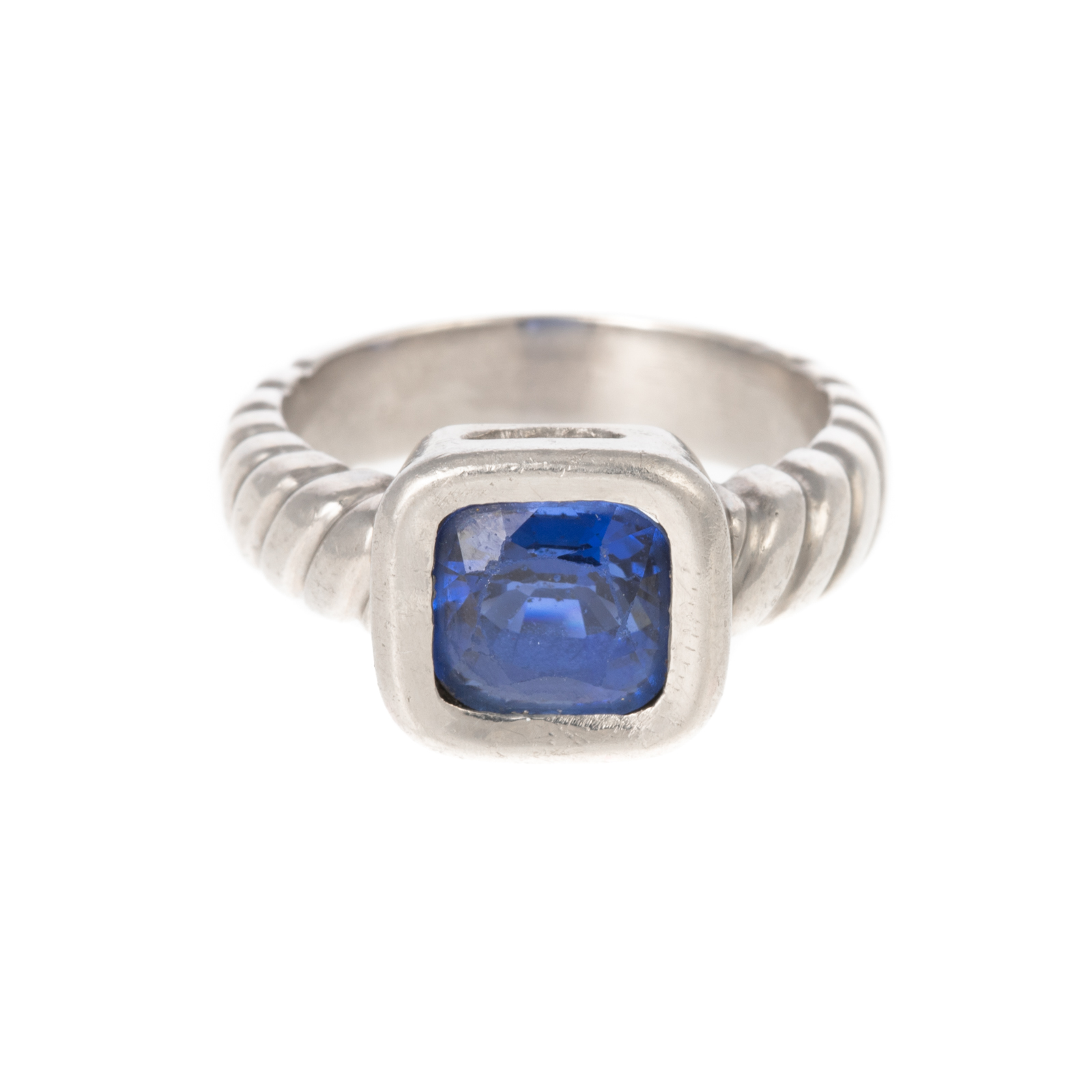 Appraisal: A CUSHION-CUT SAPPHIRE RING IN PALLADIUM Palladium twisted cable ring