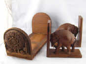 Appraisal: A pair of teak bookends elephants pushing against the books