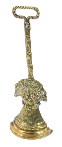 Appraisal: A brass wheatsheaf door stop with moulded base on twist