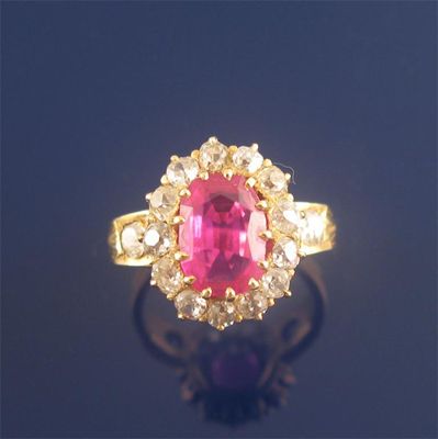 Appraisal: A ruby and diamond cluster ring the oval mixed cut