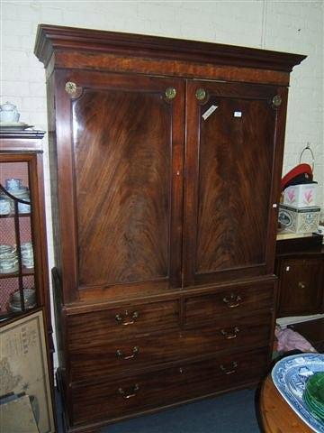 Appraisal: A George III mahogany linen press having a moulded cornice