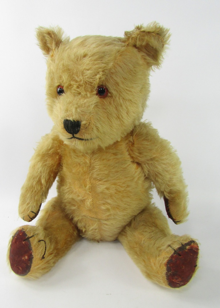 Appraisal: A golden mohair straw filled teddy bear with leather pads