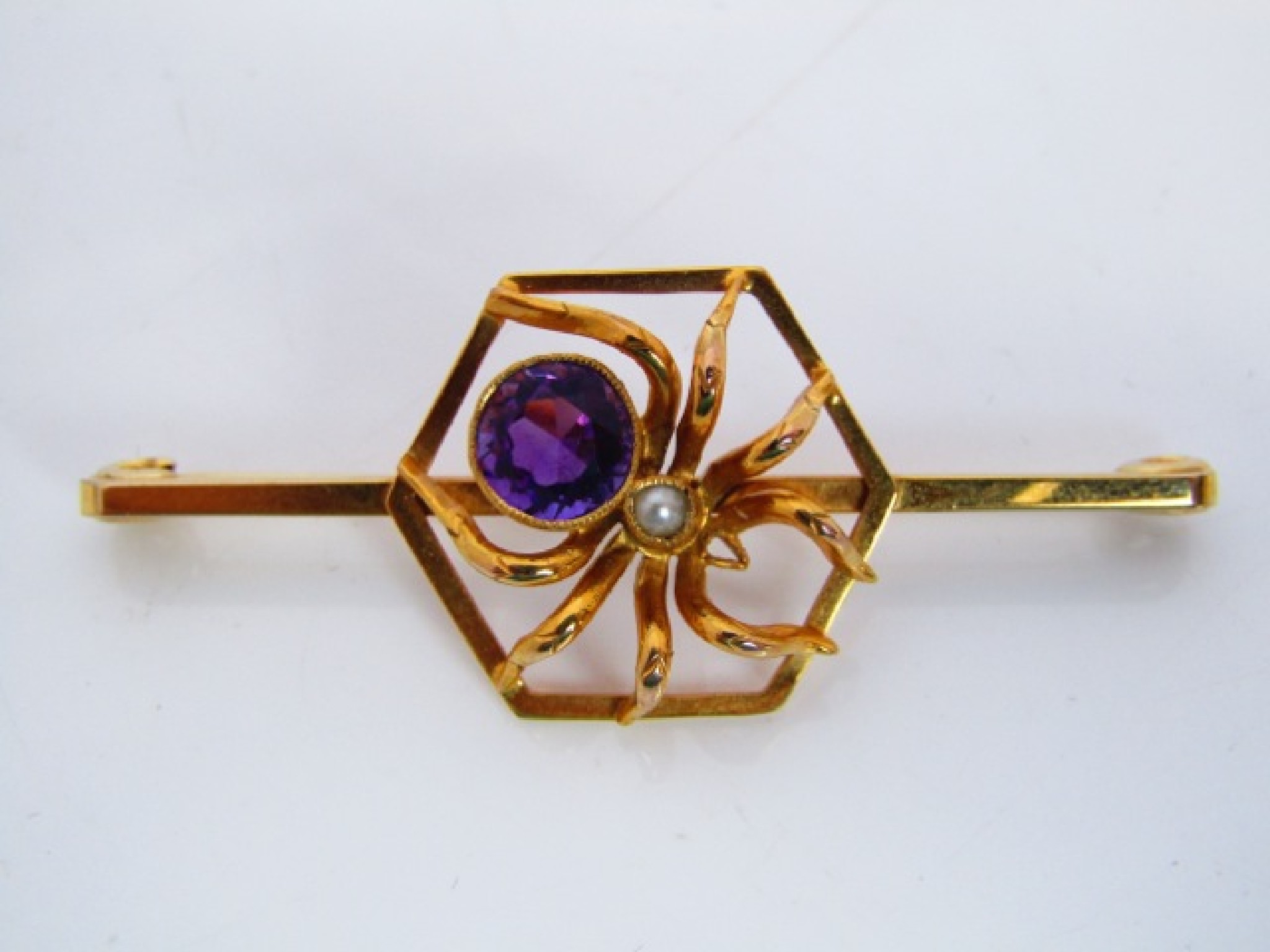 Appraisal: A ct gold bar brooch centred with a gem-set spider