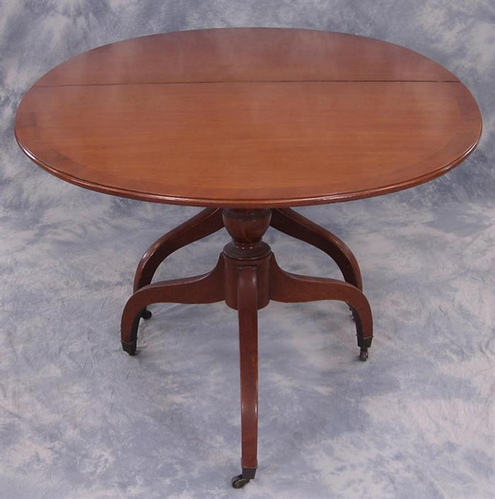 Appraisal: Oval banded mahogany dining room table with leaves each closed