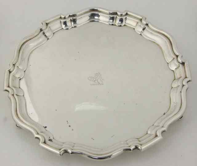 Appraisal: A circular silver salver Sheffield with piecrust border on three