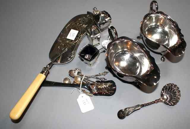 Appraisal: A PAIR OF SILVER PLATED SAUCE BOATS standing on cabriole