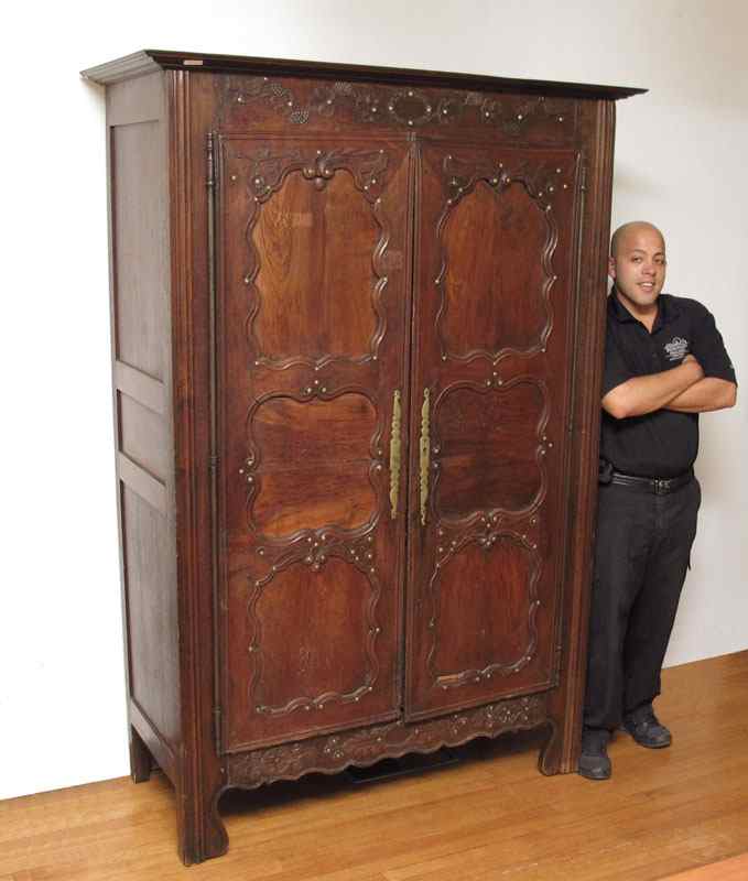 Appraisal: COUNTRY FRENCH DOOR ARMOIRE Carved floral swag top panel doors