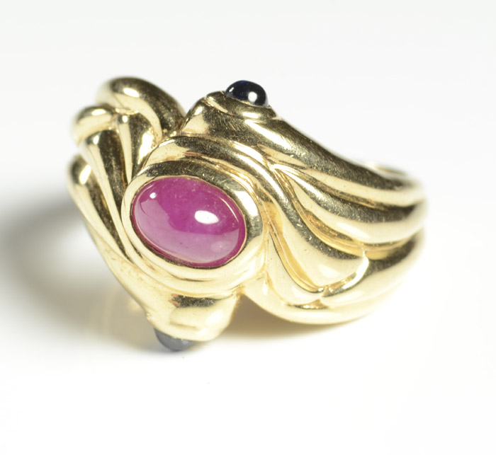 Appraisal: RUBY SAPPHIRE AND FOURTEEN KARAT GOLD RING set with a