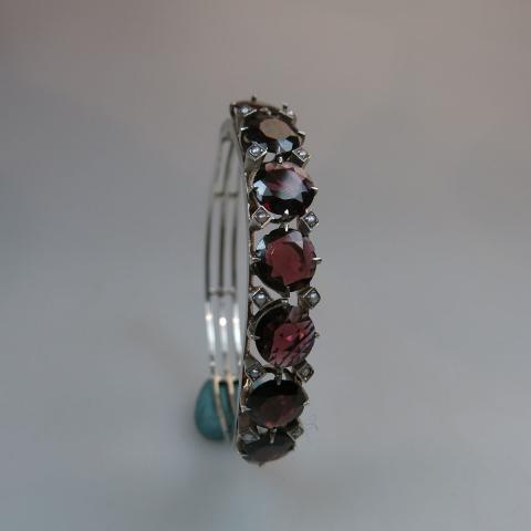 Appraisal: th Century Silver Hinged Bangle set with round cut garnets