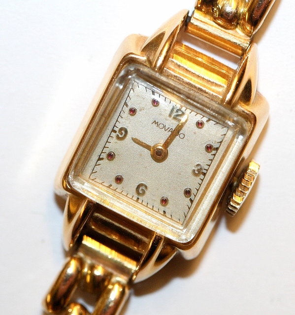 Appraisal: A LADIES CT GOLD MOVADO WATCH with a rectangular dial