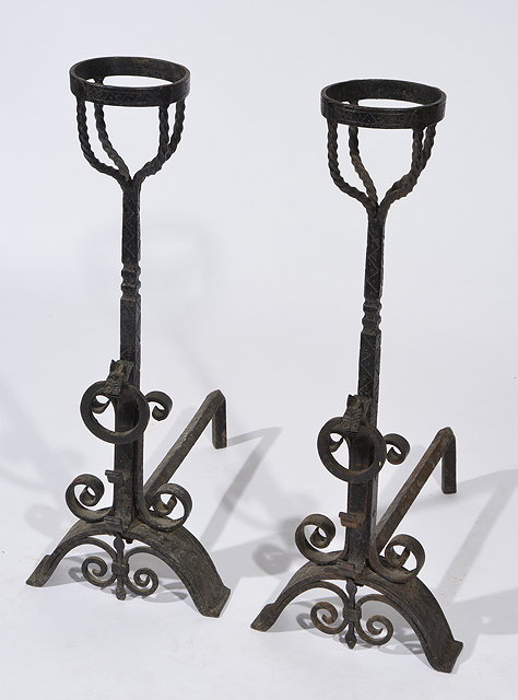 Appraisal: A PAIR OF ARTS AND CRAFTS WROUGHT IRON FIRE DOGS