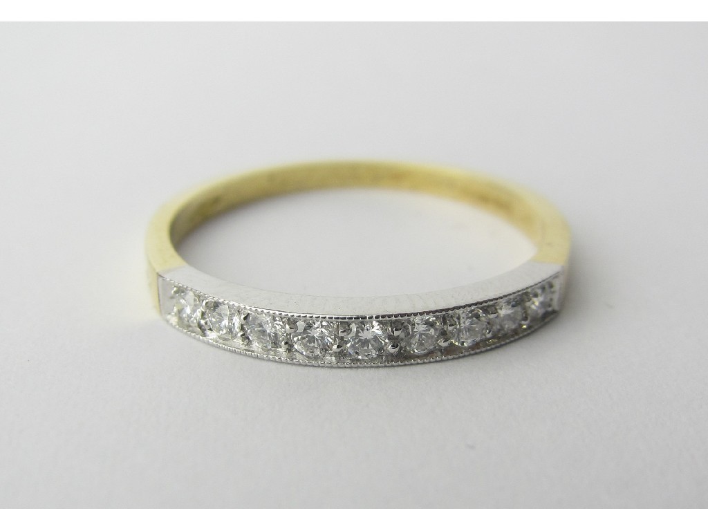 Appraisal: Eighteen carat bi colour gold diamond nine stone half hoop