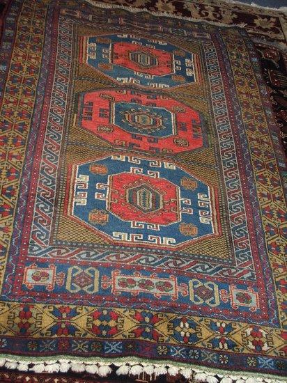 Appraisal: A TURKISH MULTI-COLOURED RUG decorated three central octagans x