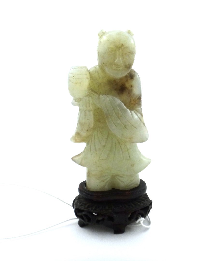 Appraisal: A Chinese pale celadon figure of a boy standing smiling