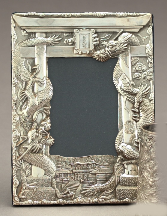 Appraisal: Embossed Sterling Silver-Faced Celestial Dragons Photograph Frame modeled as a