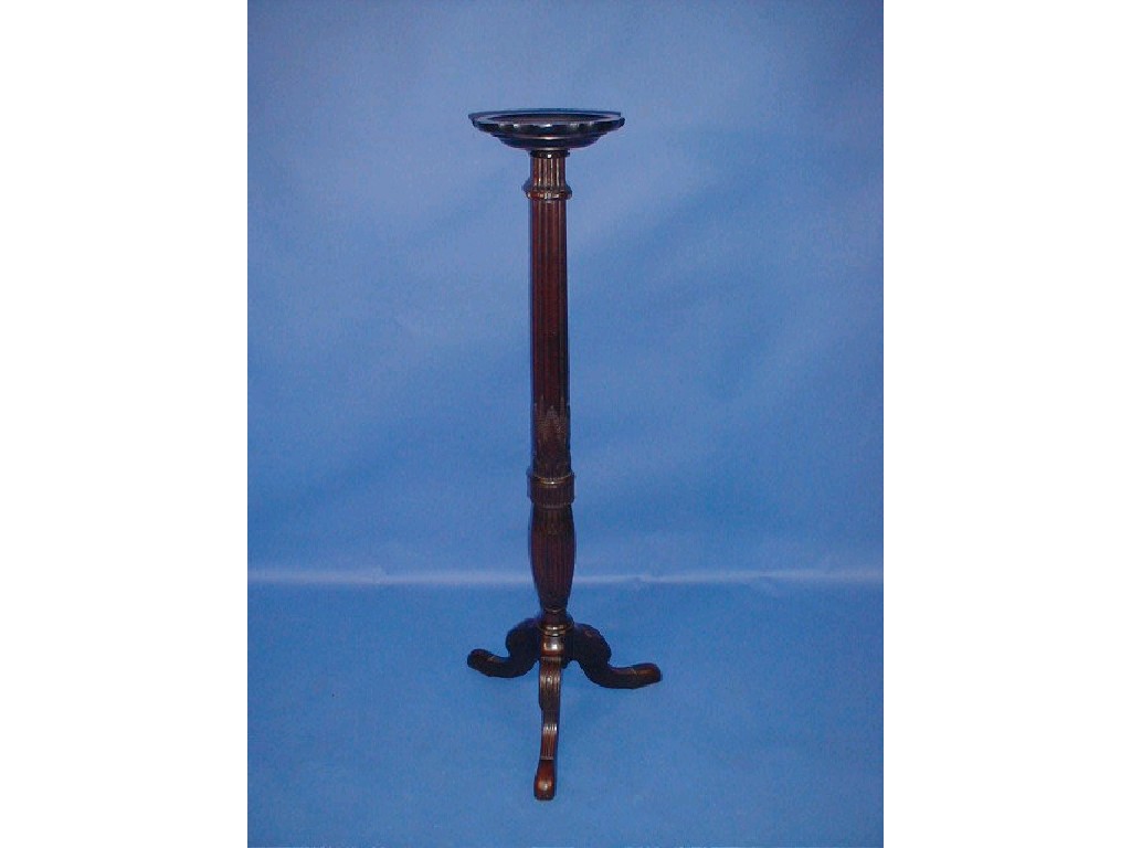 Appraisal: An Edwardian mahogany torchere stand with carved and reeded column