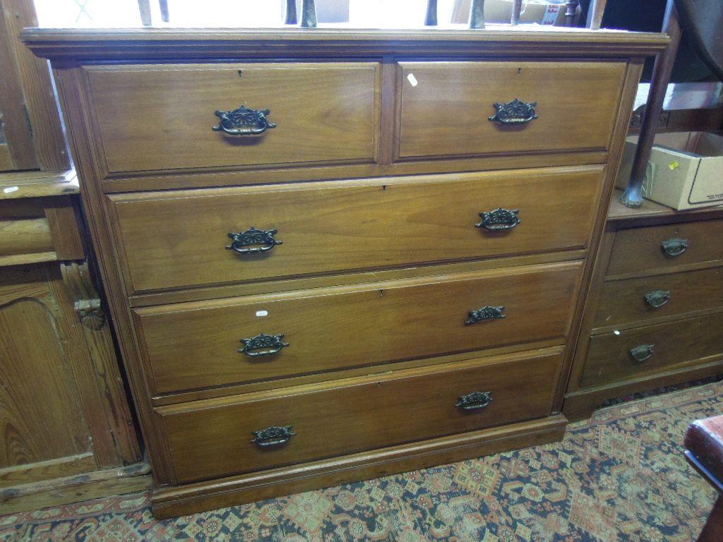 Appraisal: A late Victorian walnut chest fitted with three long and